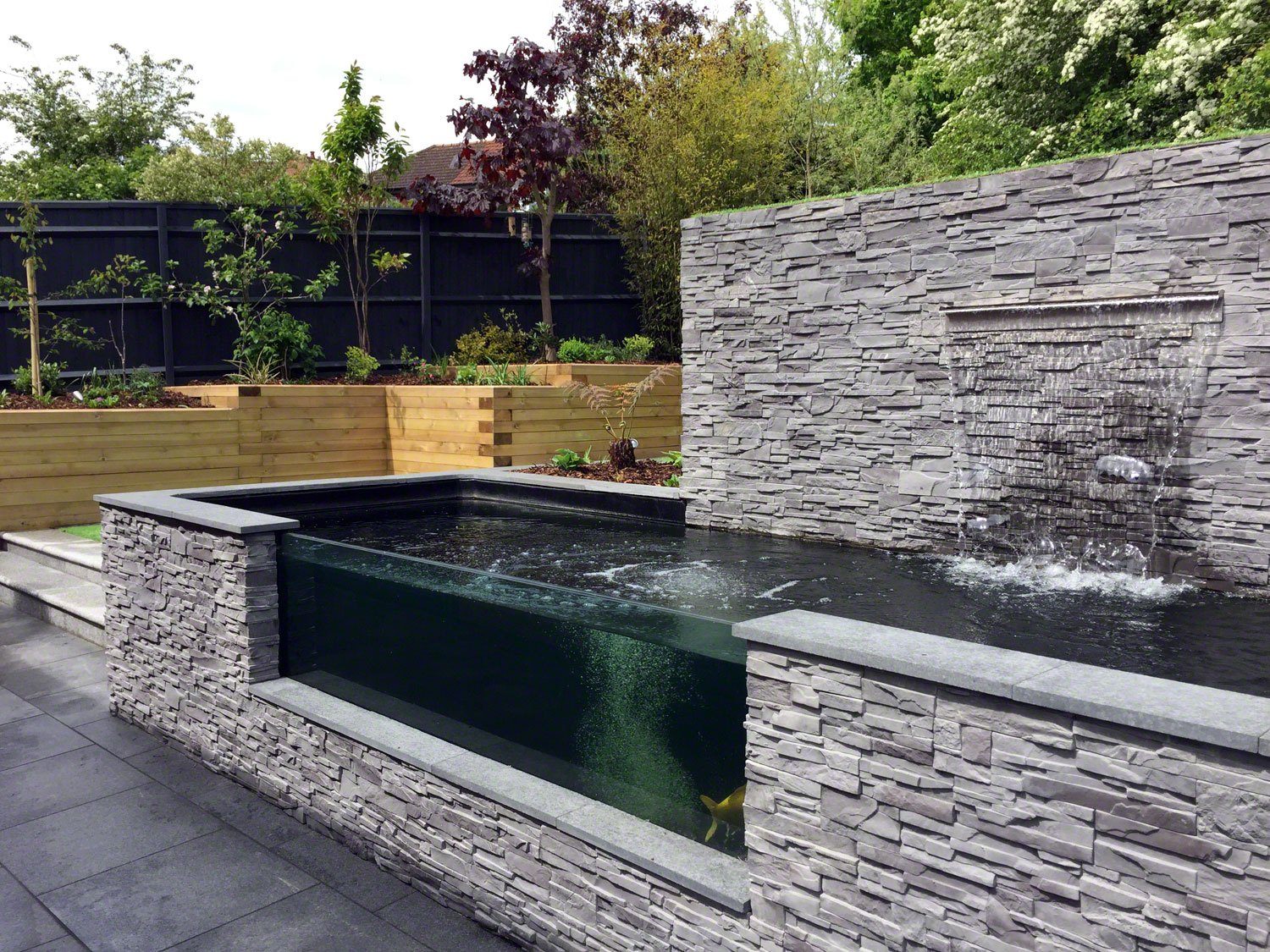 Modern Sloping Garden with Feature Koi Pond | Lush Garden ...
